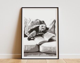May include: Black and white framed art print of a tortoise reading a book while resting on a sofa. The tortoise is the focal point, with detailed shading and texture. The open book displays text.