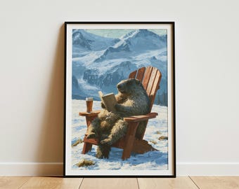 May include: A framed wall art print depicting a furry brown marmot sitting in a wooden Adirondack chair on a snowy landscape. The marmot holds an open book, and a glass of amber liquid sits on the chair arm. Snow-capped mountains fill the background.