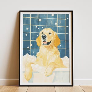 May include: Framed art print of a golden retriever dog in a bathtub with bubbles. The dog is smiling. The background has a blue tile pattern. The print is in a black frame. A charming piece of wall art.