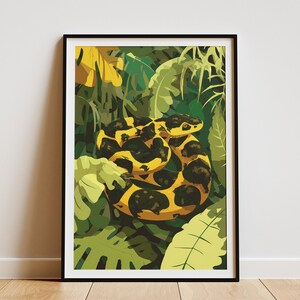 May include: Framed art print depicting a coiled snake with a yellow and black pattern, set against a backdrop of lush green foliage. The artwork has a vibrant, illustrative style, with bold colours and a tropical theme.