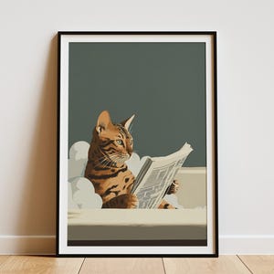 May include: Framed art print featuring a Bengal cat reading a newspaper in a bathtub. The cat has brown and black markings, with a focused expression. The background is a muted teal, and the print is in a black frame.