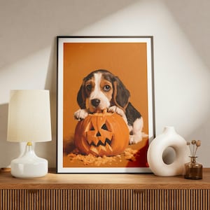 May include: A framed wall art print featuring a painting of a beagle puppy with black, white, and brown fur resting its paws on a carved orange jack-o'-lantern pumpkin. The background of the artwork is a solid, warm orange colour.