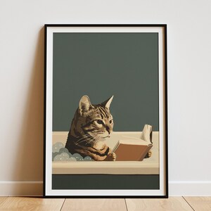 May include: A framed art print featuring a tabby cat in a bathtub, engrossed in reading a book. The cat is brown and tan, with the book open in front of it. The background is a muted teal, and the frame is black.