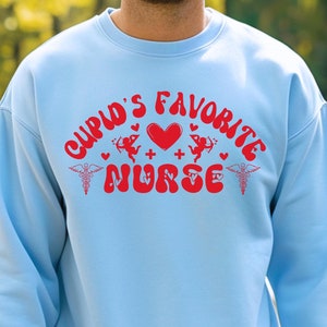 Sudadera de San Valentín con la enfermera favorita de Cupido, camiseta de San Valentín con agradecimiento a la enfermera, camiseta de San Valentín para enfermeras, regalo de San Valentín para enfermeras practicantes