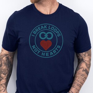 May include: Navy blue t-shirt with a teal and red graphic. The graphic is a circular design with the text "I BREAK LOOPS" at the top and "NOT HEARTS" at the bottom. The center features an infinity symbol and a red heart.