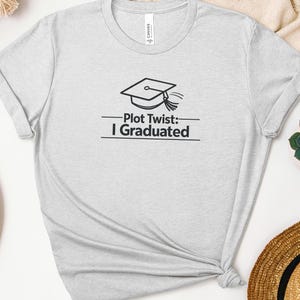 May include: A set of three ceramic mugs with a speckled, matte finish. The mugs are in shades of cream, light gray, and dark gray. Each mug has a simple, minimalist design and a rounded handle.