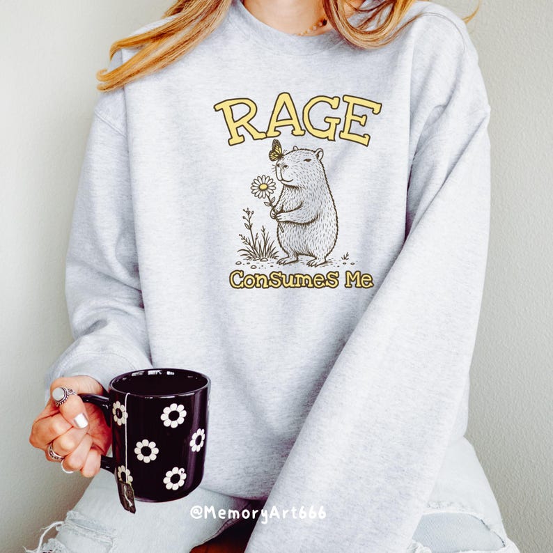 Funny capybara meme PNG SVG design featuring a cute vintage-style capybara holding a daisy flower with a butterfly resting on its head and bold retro “RAGE Consumes Me” typography. Funny sarcastic animal graphic with whimsical hand-drawn line art, soft neutral tones, and trendy unhinged aesthetic. Perfect for funny t-shirts, hoodies, mugs, tote bags, stickers, sublimation projects, Cricut SVG cut files, retro boutique apparel, instant digital download, 300 DPI transparent background.