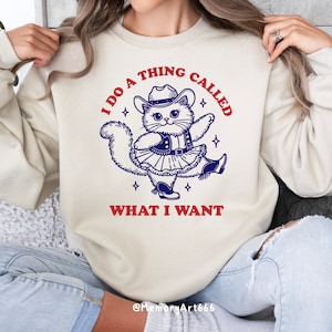 A funny retro-style illustration of a sassy cowboy cat dancing confidently, wearing a western hat, boots, and a skirt. The sarcastic quote reads “I Do A Thing Called What I Want.” Vintage hand-drawn line art with playful details and a bold, confident attitude. Adult humor design with a positive, self-love vibe, perfect for shirts, tote bags, mugs, stickers, and digital crafts. SVG and PNG digital download.