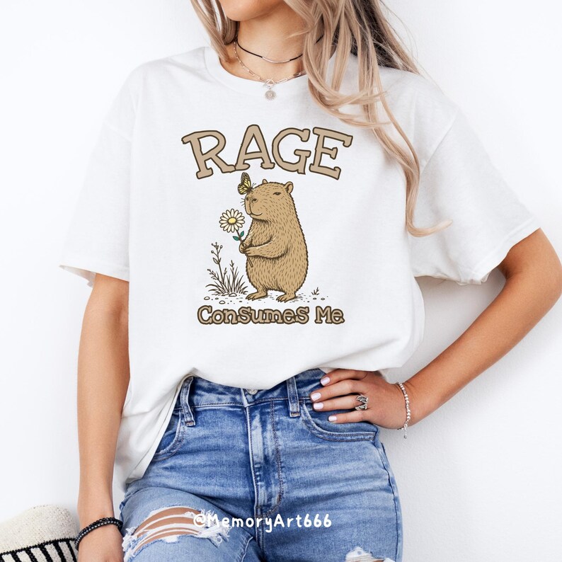 Funny capybara meme PNG SVG design featuring a cute vintage-style capybara holding a daisy flower with a butterfly resting on its head and bold retro “RAGE Consumes Me” typography. Funny sarcastic animal graphic with whimsical hand-drawn line art, soft neutral tones, and trendy unhinged aesthetic. Perfect for funny t-shirts, hoodies, mugs, tote bags, stickers, sublimation projects, Cricut SVG cut files, retro boutique apparel, instant digital download, 300 DPI transparent background.