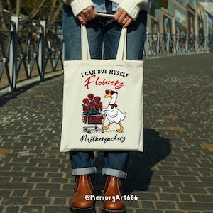 A sarcastic anti-Valentine illustration featuring a confident goose pushing a cart overflowing with red roses. The goose walks with attitude, expressing independence and zero romance vibes. Bold text reads “I can buy myself flowers” and “Motherfuckers,” creating a funny anti-love message. Vintage hand-drawn style on a beige background, perfect for anti-Valentine shirts, stickers, and digital crafts.