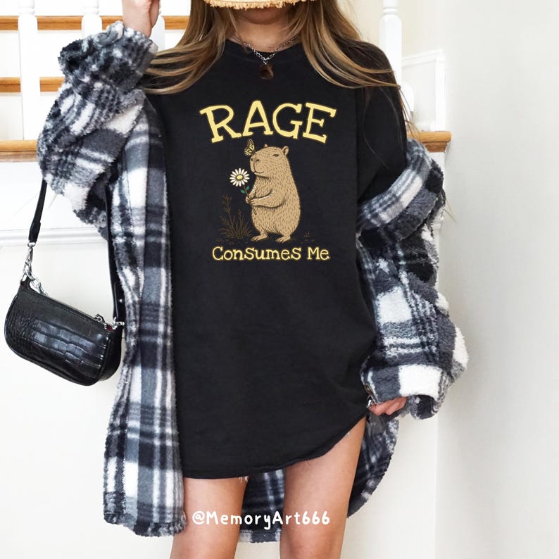 Funny capybara meme PNG SVG design featuring a cute vintage-style capybara holding a daisy flower with a butterfly resting on its head and bold retro “RAGE Consumes Me” typography. Funny sarcastic animal graphic with whimsical hand-drawn line art, soft neutral tones, and trendy unhinged aesthetic. Perfect for funny t-shirts, hoodies, mugs, tote bags, stickers, sublimation projects, Cricut SVG cut files, retro boutique apparel, instant digital download, 300 DPI transparent background.