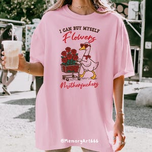 A sarcastic anti-Valentine illustration featuring a confident goose pushing a cart overflowing with red roses. The goose walks with attitude, expressing independence and zero romance vibes. Bold text reads “I can buy myself flowers” and “Motherfuckers,” creating a funny anti-love message. Vintage hand-drawn style on a beige background, perfect for anti-Valentine shirts, stickers, and digital crafts.