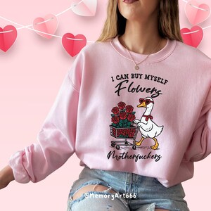 A sarcastic anti-Valentine illustration featuring a confident goose pushing a cart overflowing with red roses. The goose walks with attitude, expressing independence and zero romance vibes. Bold text reads “I can buy myself flowers” and “Motherfuckers,” creating a funny anti-love message. Vintage hand-drawn style on a beige background, perfect for anti-Valentine shirts, stickers, and digital crafts.