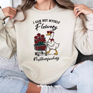 A sarcastic anti-Valentine illustration featuring a confident goose pushing a cart overflowing with red roses. The goose walks with attitude, expressing independence and zero romance vibes. Bold text reads “I can buy myself flowers” and “Motherfuckers,” creating a funny anti-love message. Vintage hand-drawn style on a beige background, perfect for anti-Valentine shirts, stickers, and digital crafts.