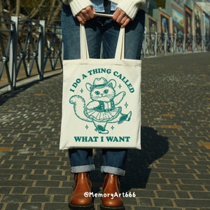 A funny retro-style illustration of a sassy cowboy cat dancing confidently, wearing a western hat, boots, and a skirt. The sarcastic quote reads “I Do A Thing Called What I Want.” Vintage hand-drawn line art with playful details and a bold, confident attitude. Adult humor design with a positive, self-love vibe, perfect for shirts, tote bags, mugs, stickers, and digital crafts. SVG and PNG digital download.