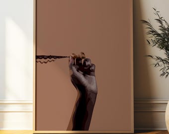 May include: A framed art print featuring a hand holding a dark, wavy line against a solid brown background. The artwork has a minimalist style with a focus on form and shadow, creating a striking visual.