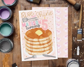 May include: A pink and gold birthday party invitation with a cartoon illustration of a stack of pancakes with a lit candle. The text on the invitation reads "Rise and Shine, Let's Celebrate Madison Turning 5".