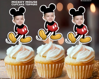 May include: Three Mickey Mouse cupcake toppers with personalized photos. Each topper features a red and yellow Mickey Mouse character with a child's face in the head. The toppers are 2.5 inches by 3.5 inches and are printed on 8.5 inch by 11 inch paper.