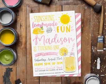 May include: A pink and yellow lemonade-themed birthday party invitation for a girl named Madison turning one. The invitation features a sun, lemons, and a glass of lemonade. The text reads "Sunshine Lemonade and Fun Madison is turning one. Join us to celebrate Saturday, August 23rd from 5pm to 7pm. Madison's Lemonade Stand 5641 Lemonade Ave Gilbert, AZ 76251 RSVP Jennifer 520 555 1239 or jenggmail.com Backside Included."