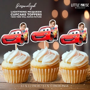 May include: Three red Lightning McQueen cupcake toppers with a personalized photo of a child in the driver's seat. The toppers are 2.7 inches by 2.2 inches and are printed on 8.5 inch by 11 inch paper.