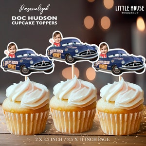 May include: Four blue and yellow Doc Hudson cupcake toppers with a child's face on each. The toppers are 2 x 3.2 inches and are printed on an 8.5 x 11 inch page.
