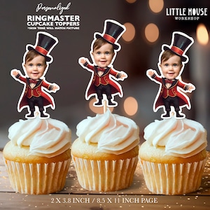 May include: Three personalised ringmaster cupcake toppers featuring a child's face in a red and black ringmaster costume with a top hat. The toppers are 2 inches by 3.8 inches and are printed on an 8.5 inch by 11 inch page.