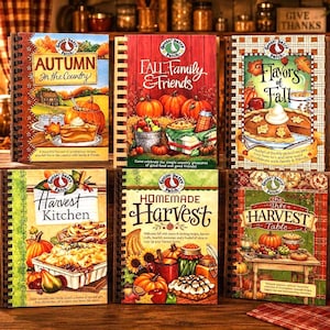 May include: Six spiral-bound cookbooks titled Autumn in the Country, Fall Family & Friends, Flavors of Fall, Harvest Kitchen, Homemade Harvest, and The Harvest Table, each featuring colorful illustrations of pumpkins, pies, and seasonal food.