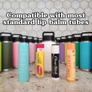 May include: A collection of colorful lip balm tubes and insulated water bottles. The text at the top reads "Compatible with most standard lip balm tubes." The lip balms are various colors, including blue, yellow, and white. The water bottles are in shades of green, pink, and blue.