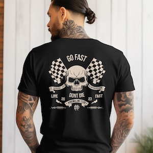 May include: Black t-shirt with a skull graphic and the text "GO FAST", "LIVE 20", "DONT DIE", "23 FAST", "SPEED", "FREEDOM", and "ADRENALINE CLUB".