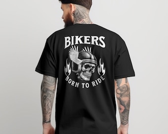 May include: Black t-shirt with a white graphic of a skull wearing a helmet with wings and flames. The text "Bikers Born to Ride" is printed below the skull.