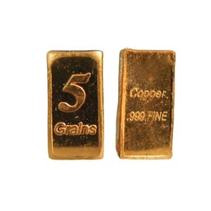 May include: Two copper bars are shown, one with "5 Grains" and the other with "Copper .999 FINE" text. The bars are gold-coloured and rectangular. The background is plain white.