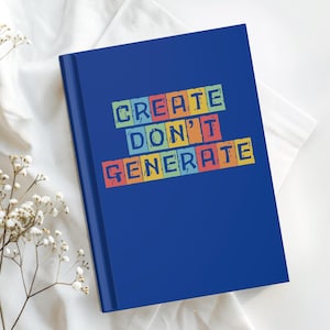 May include: A dark blue hardcover notebook featuring the text "CREATE DON'T GENERATE" printed in a blocky, multi-colored style with individual letters set against small, rectangular backgrounds of yellow, red, green, and light blue.