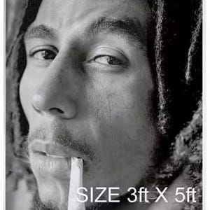 May include: Black and white photo of Bob Marley smoking a cigarette. The photo is on a white background with the text "SIZE 3ft X 5ft" and "BOB MARLEY" in red, yellow, and green.
