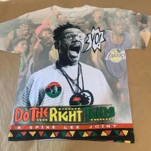May include: White t-shirt with a colorful all-over print featuring a man with glasses yelling "Yo!" in a speech bubble. The print also includes the text "Do The Right Thing" and "A Spike Lee Joint".
