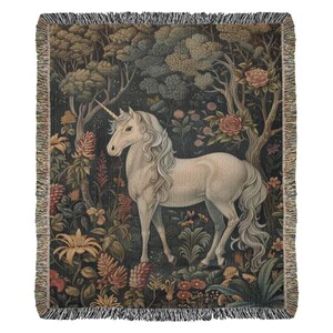 May include: A white unicorn with a long horn stands in a lush forest setting. The unicorn is surrounded by colorful flowers and greenery, creating a magical and whimsical scene.