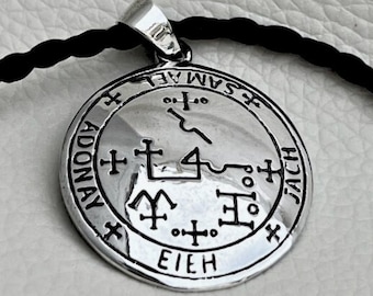 May include: Silver pendant with a black and white sigil, the words "EIEH", "ADONAY", "JACH", and "SAM AEL" are inscribed around the sigil.