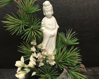 Statua di Buddha in porcellana su piedistallo