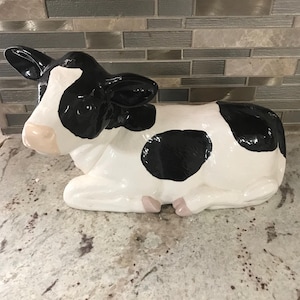 Black White Cow Sitting Down Sculpture Statue Ceramic Artwork Decorative Collectible Decor (11 Inches L’ X 5 Inches W’ X 7 1/2 Inches H’)