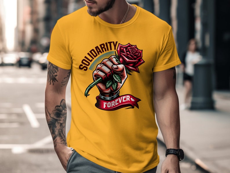 May include: Yellow t-shirt with a graphic of a hand holding a red rose with the text "Solidarity Forever".