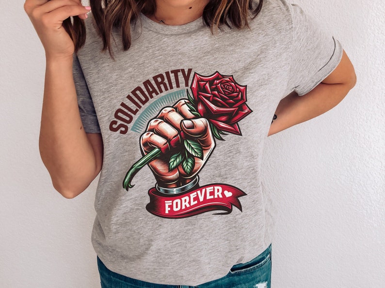 May include: Gray t-shirt with a graphic of a fist holding a red rose with green leaves. The text "Solidarity Forever" is printed on a red ribbon.
