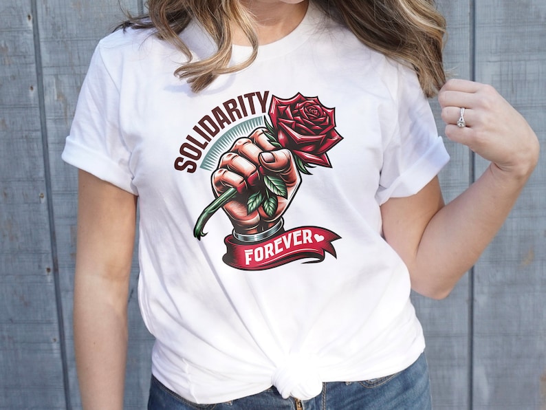 May include: White t-shirt with a graphic of a hand holding a red rose with green leaves. The text "Solidarity Forever" is printed on the shirt.