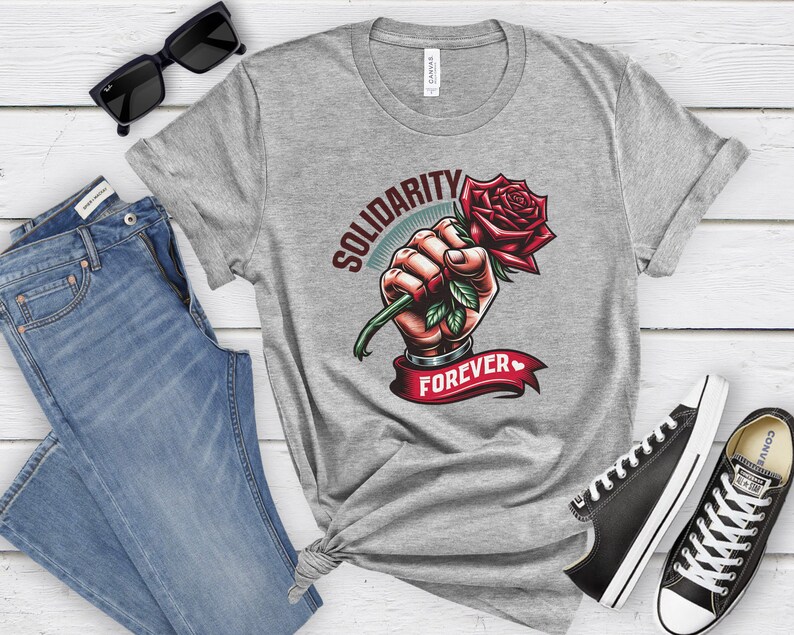 May include: Gray t-shirt with a graphic of a fist holding a red rose with the text "Solidarity Forever" printed on it.