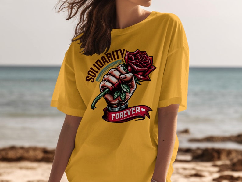 May include: Yellow t-shirt with a graphic of a hand holding a red rose with the text "Solidarity Forever" on a banner.