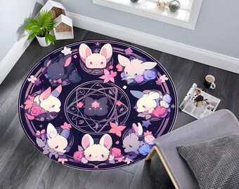 May include: Round rug with a dark blue background featuring cartoon bunnies, flowers, and stars. The design includes a central geometric shape and a border with more bunnies and floral elements. The rug is placed on a dark wood floor.