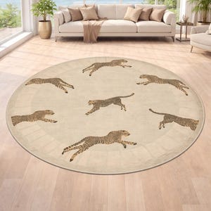 May include: A round area rug with a cream-colored background and a repeating pattern of cheetahs in motion. The cheetahs are depicted in shades of brown and tan, adding a touch of the wild to the room's decor.