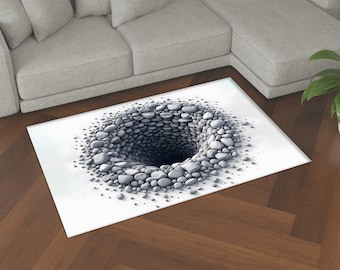 May include: A white rug with a 3D optical illusion of a hole in the ground filled with gray stones.