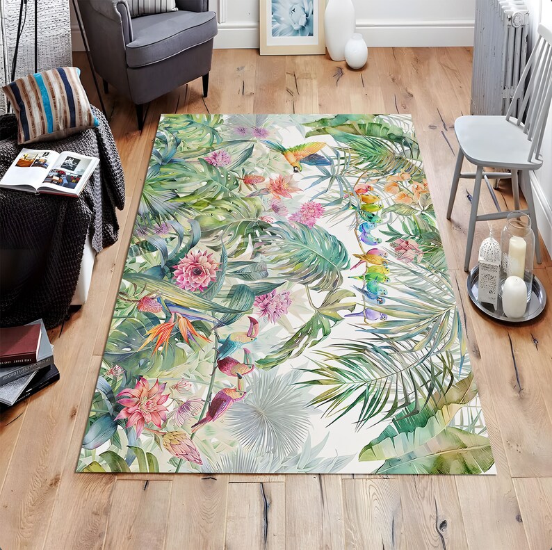 May include: A tropical-themed area rug with a white background featuring colorful toucans, parrots, and flowers. The rug has a green, white, and pink color scheme.