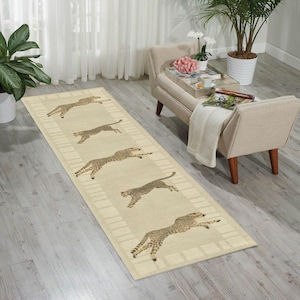 May include: A beige runner rug featuring a repeating design of cheetahs in mid-leap. The cheetahs are brown with black spots. The rug has a cream border and is laid on a light wooden floor. The rug's length is approximately 240 cm.