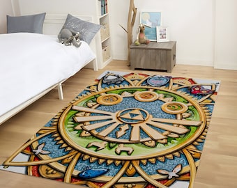 May include: A colorful rug with a large, intricate design featuring a golden triforce symbol surrounded by smaller symbols and patterns. The rug is on a wooden floor in a room with a bed and furniture.