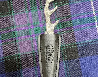 May include: A silver stag antler bottle opener with a black leather sheath. The sheath has the text "Braemar - Highland Leather -" embossed on it.